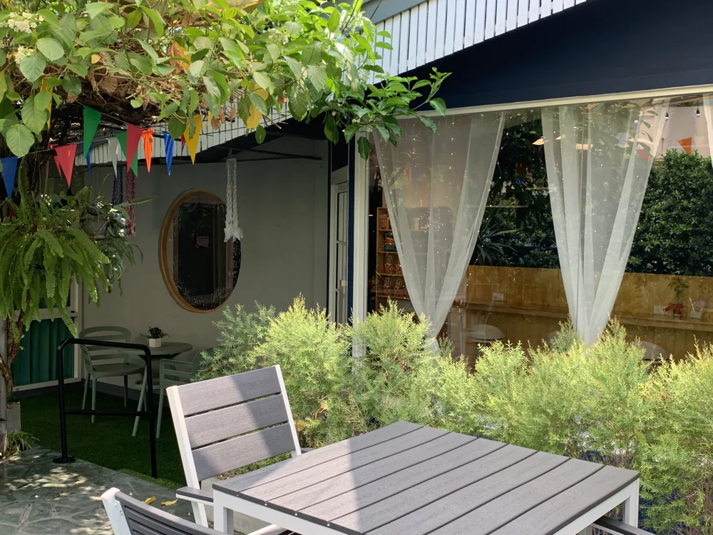 Garden table and greenery outside Bulls' Cafe